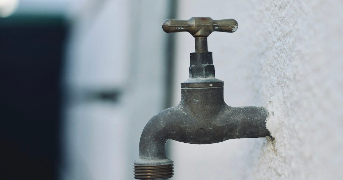 Close-up of an outdoor metal water faucet