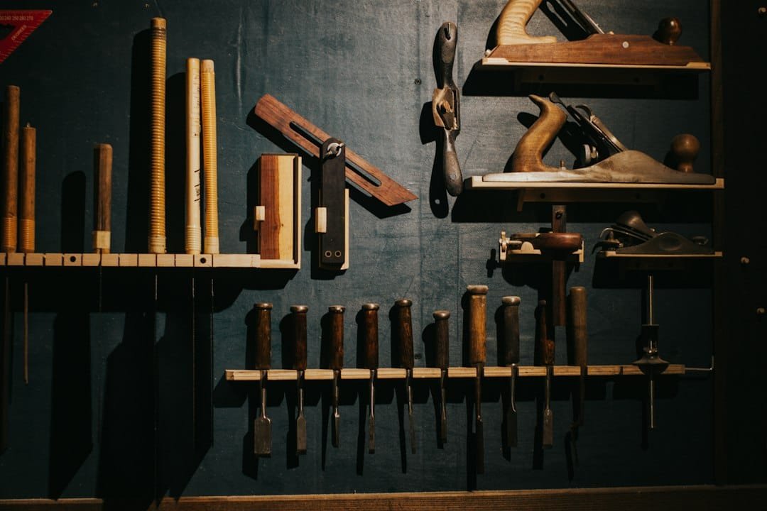 Various woodworking tools neatly arranged on a dark wall
